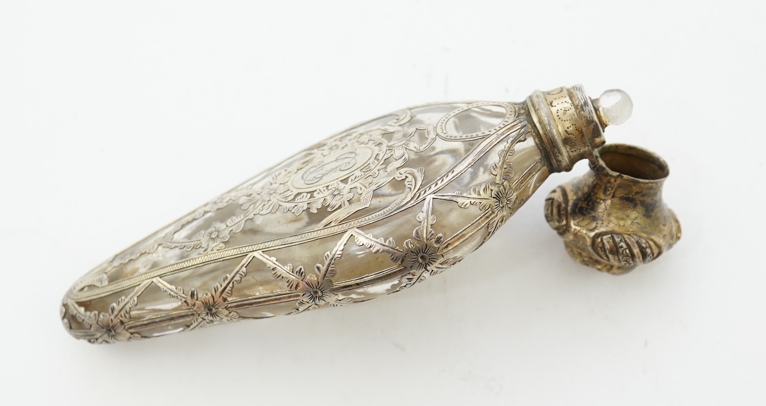 A late 19th century French parcel gilt white metal mounted and overlaid glass scent flask, with hinged cover and glass stopper